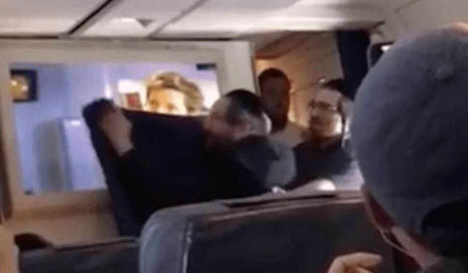 VIDEO: Hasidic Jews cheer as they cover up a screen showing in-flight movie