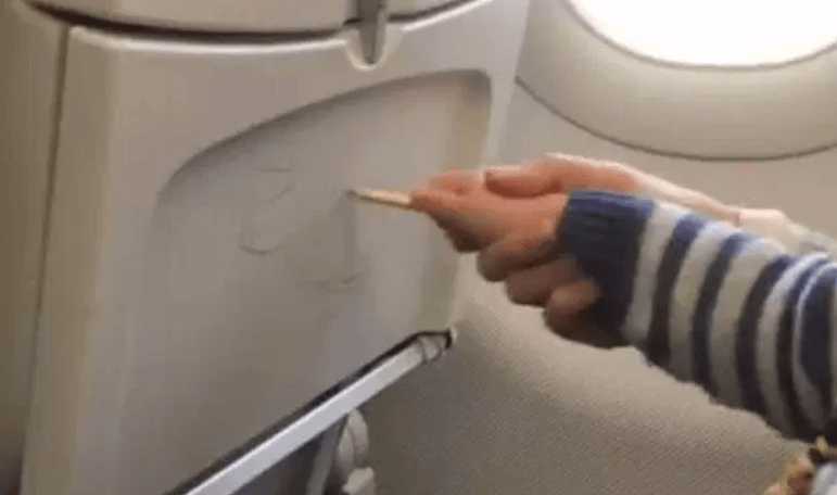 VIDEO: Parent helps her child graffiti on plane seats