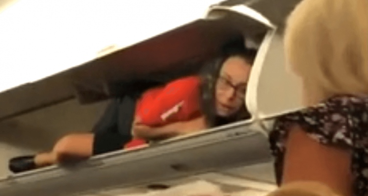 Strange moment a Southwest flight attendant greets passengers from inside an overhead locker | Secret Flying Strange moment a Southwest flight attendant greets passengers from inside an overhead locker | Secret Flying
