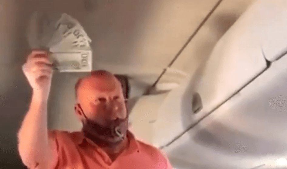 VIDEO: Man randomly hands out $100 bills to everyone on flight