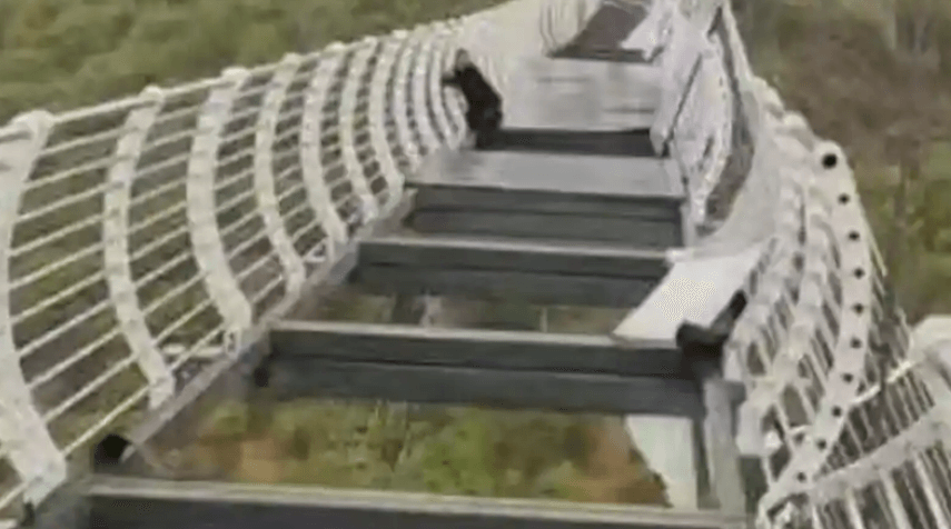 Glass panels on Chinese bridge fall out leaving tourist clinging for life