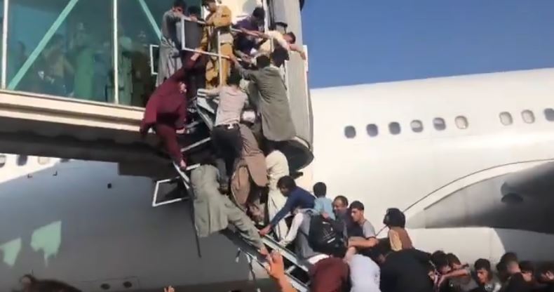 VIDEO: Chaos at Kabul Airport as Afghans climb on planes in attempt to flee the country